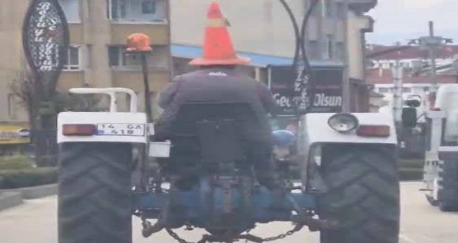 Bolu'da trafikte ilginç görüntü: Başına duba geçirip traktör sürdü